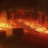 There's a strange sort of serenity in the cemetary as lights dot the graves.