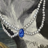 A beautiful pearl necklace with sapphire stone.